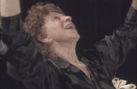 Close up of Anna Halprin raising her arms