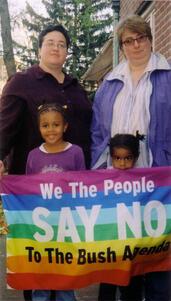 Marla Brettschneider and Family with Anti-Bush Banner, 2004