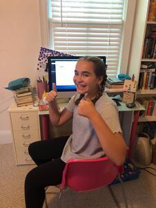 Girl seated at computer for online school during pandemic