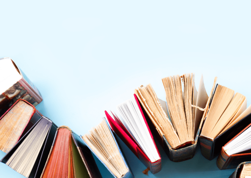 Photo of Books Arranged in an S-Shaped Pattern Across a Blue Background