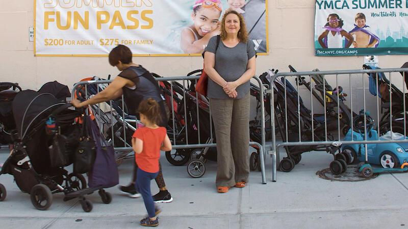 Therese Shechter stands in front of a bunch of strollers in My So-Called Selfish Life