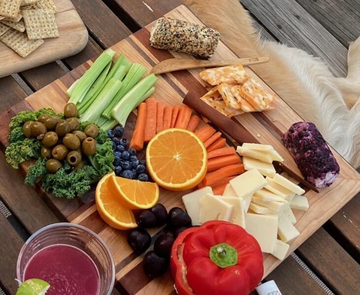 A charcuterie board with cheese and fruit