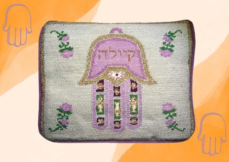 Needlepointed tallit bag with hamsa on orange background