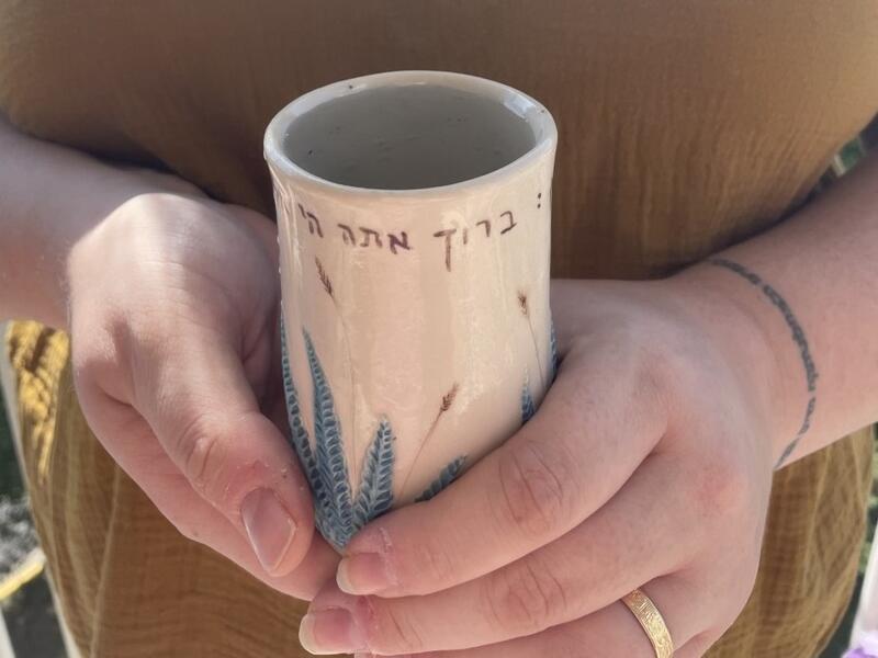 Close up of hands holding Miriam's Cup