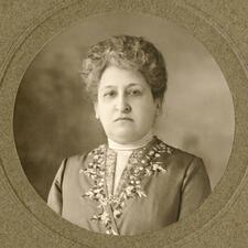 Close up portrait of Aletta Jacobs, wearing a coat embroidered with flowers