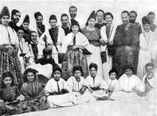 About two dozen adults and children pose for a group photo.