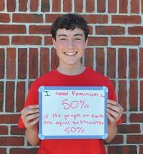 Boy Holding Femininjas Sign