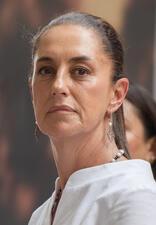 Claudia Sheinbaum with hair pulled back wearing a white shirt