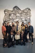 Group of people standing in front of artwork