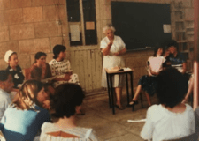 Alice Shalvi at the Pelech School - woman standing with other people seated around her