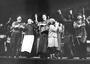 Bea Arthur as Yente in Fiddler on the Roof - center of a row of people singing in musical