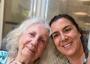 Faces of two women, mother and daughter, one with white, wavy hair and one with dark hair worn up