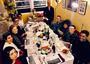 A group of people seated around a seder table. 