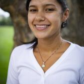 Photo of Shoshanna Hemley, in front of a tree wearing a white shirt