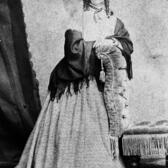 Portrait of Emma Mordecai in a nineteenth century dress with a shawl and curled hair 