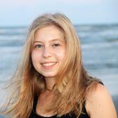 Photo of Madeline Canfield, the beach in the background.