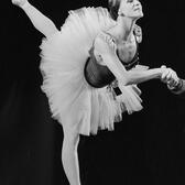 Melissa Hayden dancing en pointe with left leg extended behind her wearing a tutu on stage in Amsterdam