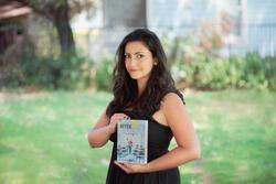 Photo of Emily Barth Isler Holding Her Book, "After/Math"