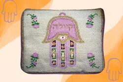 Needlepointed tallit bag with hamsa on orange background