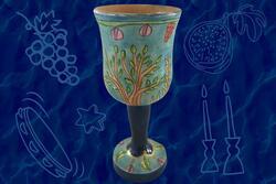 Blue kiddush cup on dark blue patterned background