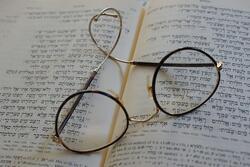 Glasses Resting on Open Tanakh