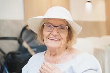 Elderly woman with white hair and a hat