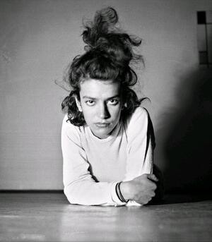 Eva Besnyö leaning on her elbows on the floor, with her hair up