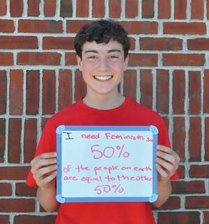 Boy Holding Femininjas Sign