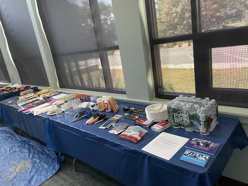 Long table with various art making materials