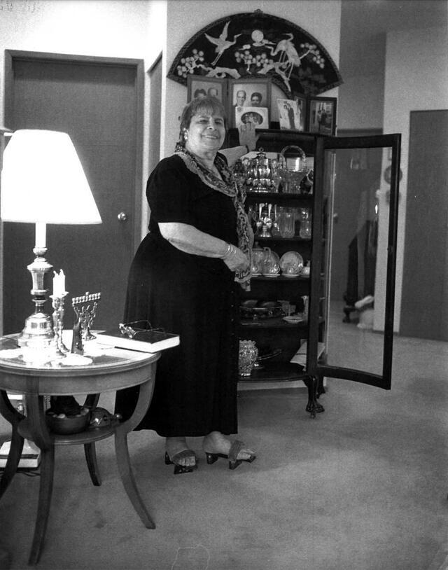 Leni LaMarche standing by cabinet