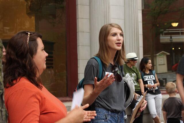 Twersky fellow Lucy Marshall standing and talking to a small group of people