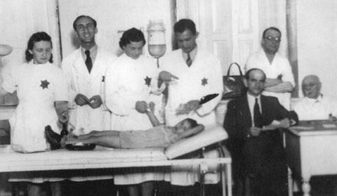 Nurses and Doctors Treat a Child in the Ghetto, Bedzin, Poland