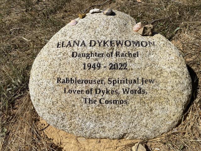 round gravestone with epitaph for Elana Dykewomon