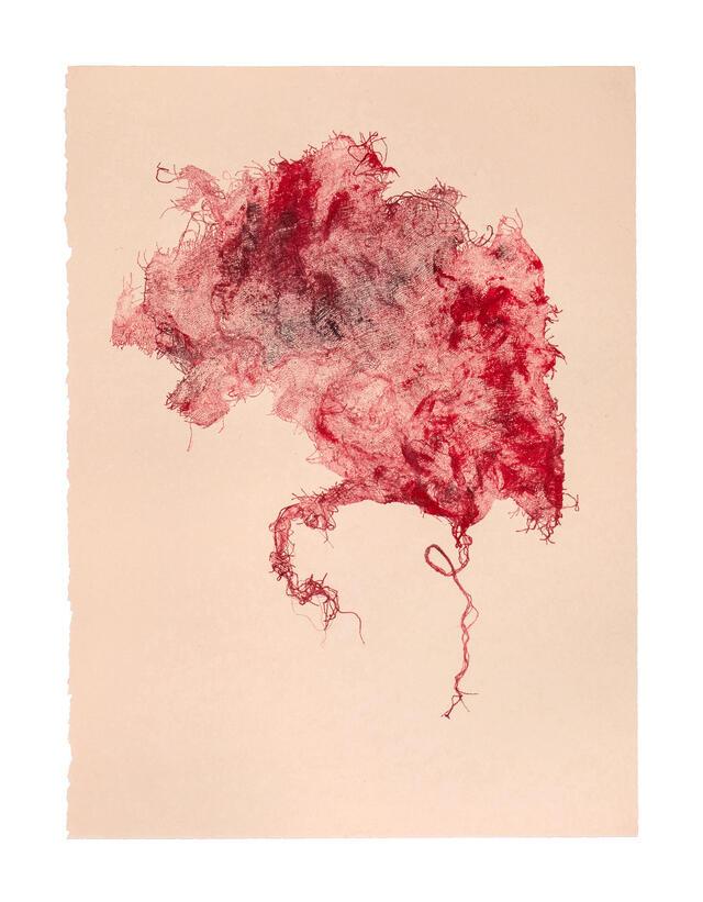 Image of red ink blot on off-white background