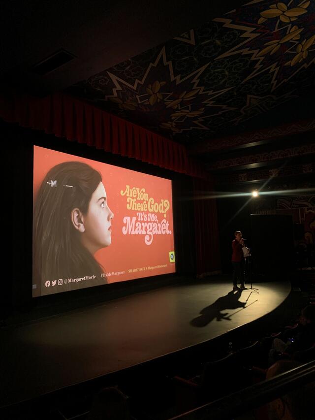 Are You There God? It's Me, Margaret screening photo: empty stage with film title and image projected on screen