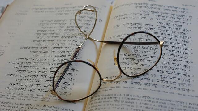 Glasses Resting on Open Tanakh