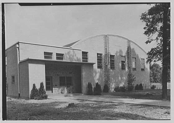 The exterior of a gymnasium with a curved roof